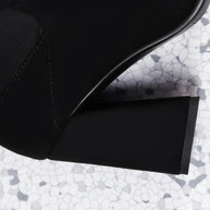 Close-up of a black shoe with a textured gray surface