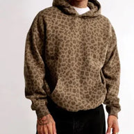 Person wearing a leopard print hoodie on a white background