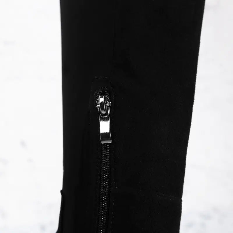 Close-up of a black jacket with a zipper and brand logo on a white background