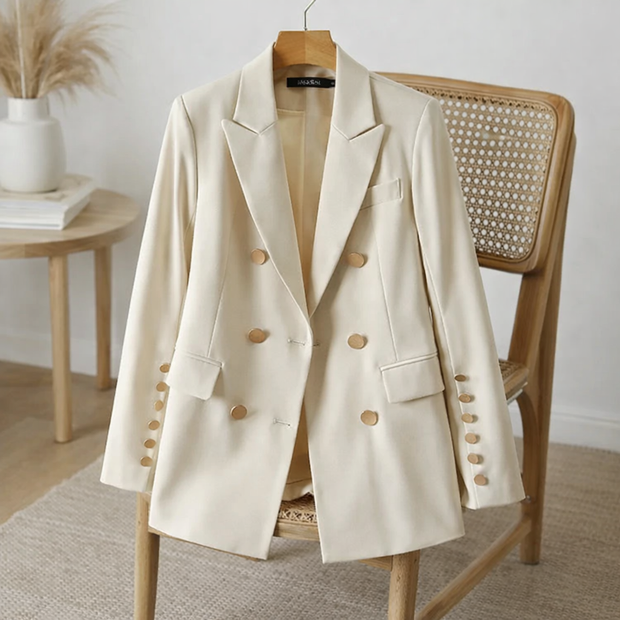 Beige blazer on a wooden chair in a minimalistic room.