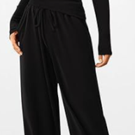 Black jumpsuit worn by a model on a white background