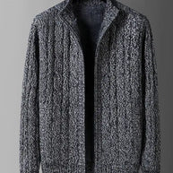 Gray cable knit sweater on a mannequin against a gray background