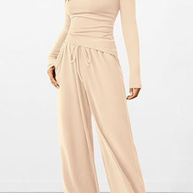 Beige jumpsuit worn by a model on a white background