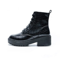 Black crocodile-patterned boot on a white background