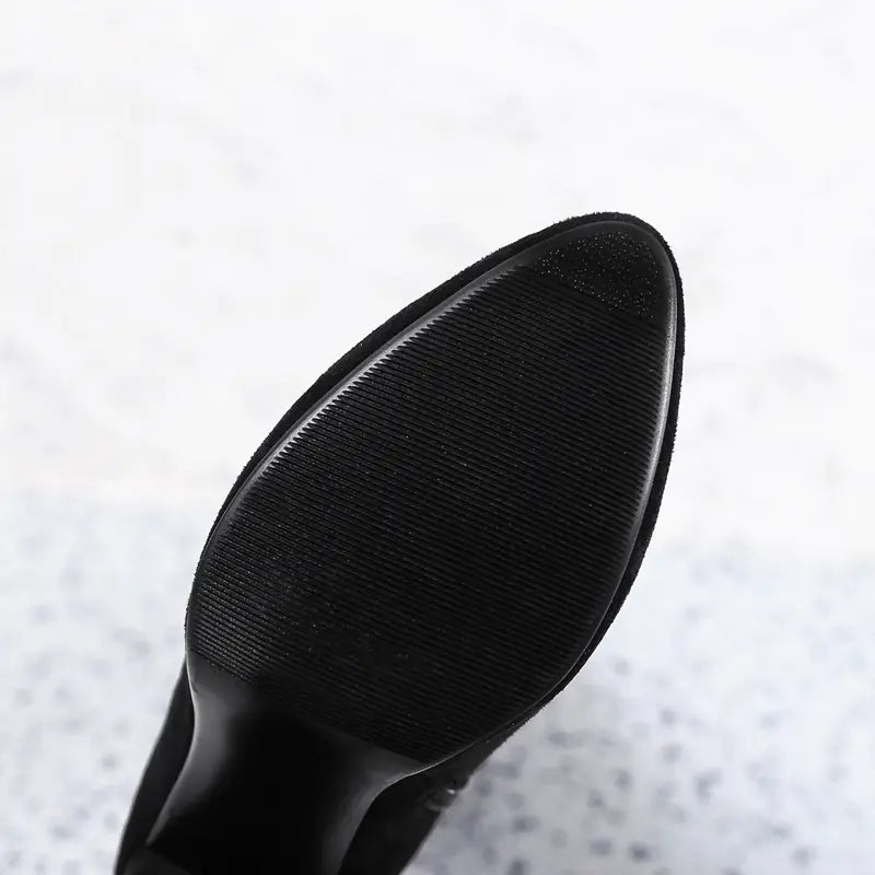 Close-up of a black shoe sole on a light gray background