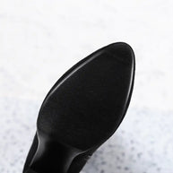 Close-up of a black shoe sole on a light gray background