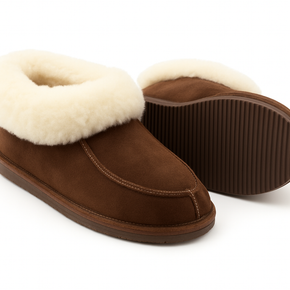 Pair of brown slippers with white fur lining on a white background