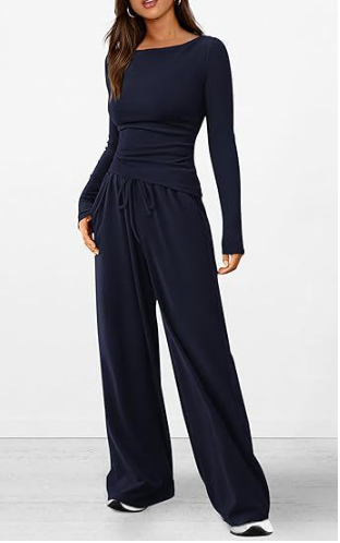 Navy blue jumpsuit worn by a model on a white background