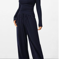 Navy blue jumpsuit worn by a model on a white background