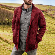 Man wearing a red knitted cardigan in a natural setting