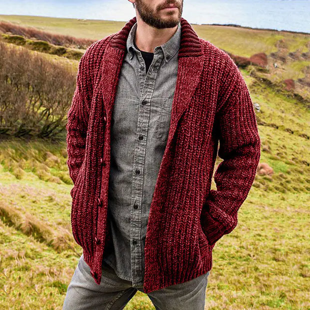 Man wearing a red knitted cardigan in a natural setting