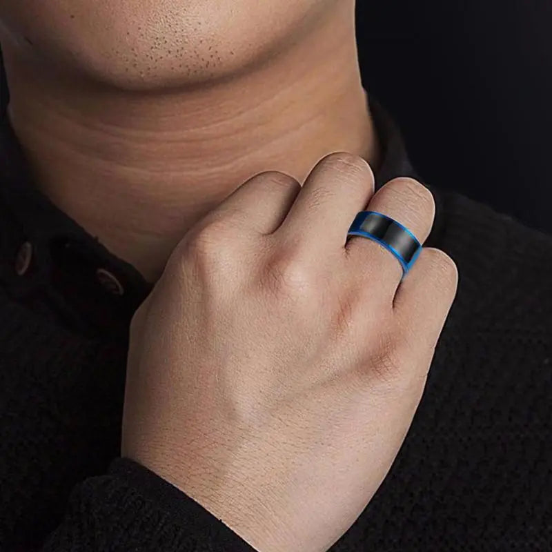 Close-up of a hand wearing a blue smart ring on a dark background
