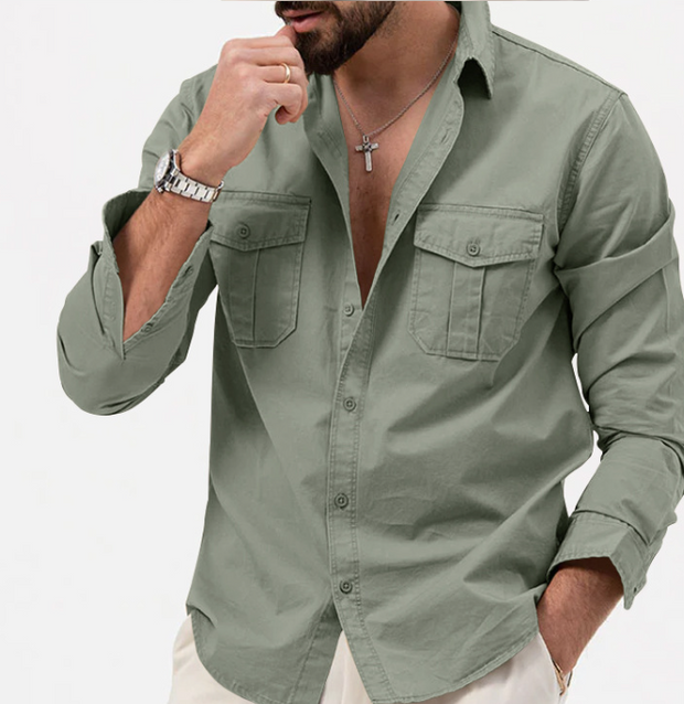 Man wearing a green shirt with rolled-up sleeves on a white background