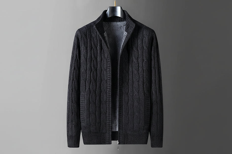 Dark gray cable knit sweater on a hanger with flame graphic indicating thick fleece lining.