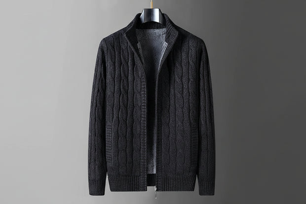 Dark gray cable knit sweater on a hanger with flame graphic indicating thick fleece lining.