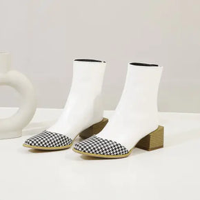 White ankle boots with black and white checkered shoes on a light gray background