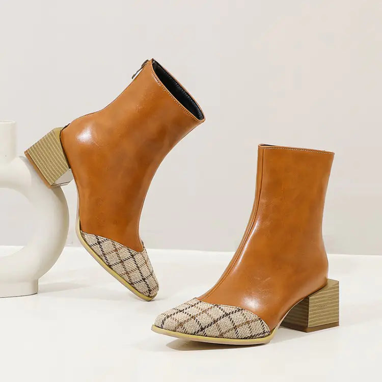 Pair of brown ankle boots with patterned toes on a white background