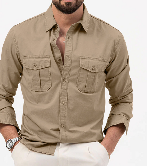 Man wearing a beige button-up shirt with rolled-up sleeves on a white background